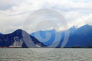 Lake Maggiore Italy on the background of beautiful mountains and cloudy sky