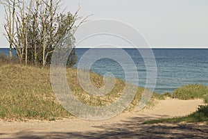 Lake michigan dunes entrance to water on sunny spring morning wi