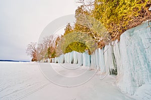 Lake Michigan island cliffs covered in sheets of blue ice in winter