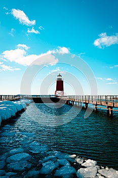 Charlevoix, MI /USA - March 3rd 2018:  Lake Michigan thawing out at the South Pier lighthouse in Charlevoix MI