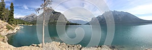 Lake Minnewanka, Banff National Park, panorama view, coast, mountains and water.