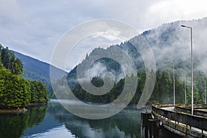 lake and misty forest in mountains in a rainy day
