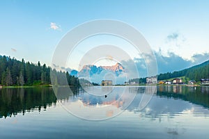Lake Misurina in Dolomites mountain, Italian Alps, Belluno, Italy. Alpine Lago di Misurina with reflection and building photo