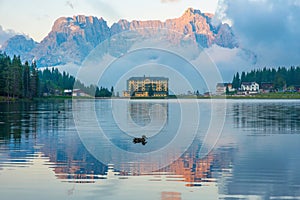 Lake Misurina in Dolomites mountain, Italian Alps, Belluno, Italy. Alpine Lago di Misurina with reflection and swiming photo