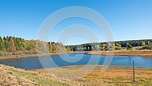 Lake `Mittlerer Pfauenteich` in the Harz mountains, Germany, with low water level because of a dry summer