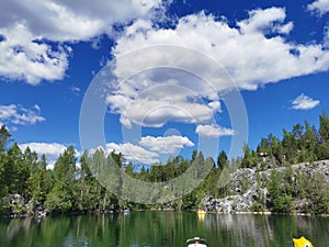 Lake Montferrand with turquoise water and pleasure catamarans in the Ruskeala Mountain Park on a sunny summer day