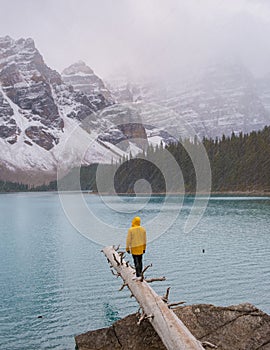 Lake moraine during a cold snowy day in Canada, turquoise waters of the Moraine lake with snow