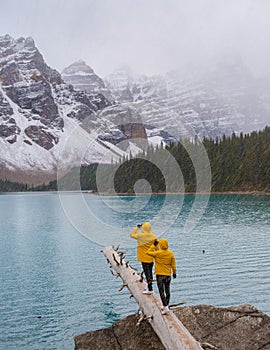 Lake moraine during a cold snowy day in Canada, turquoise waters of the Moraine lake with snow