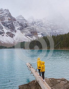 Lake moraine during a cold snowy day in Canada, turquoise waters of the Moraine lake with snow