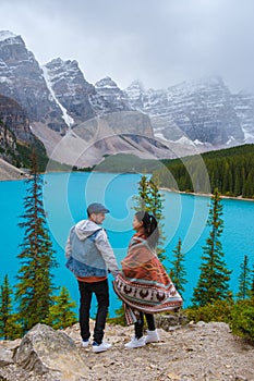 Lake moraine during a cold snowy day in Canada, turquoise waters of the Moraine lake with snow