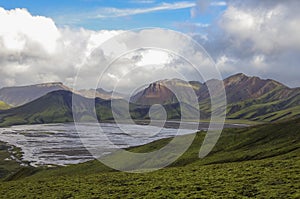 Lake and moss-covered volcanic mountains. Landmannalaugar. Iceland