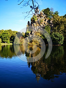 Lake and mountain in Buttes Chaumont park in Paris