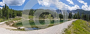 Lake on mountain Petzen with forrest and mountain Hochpetzen in photo