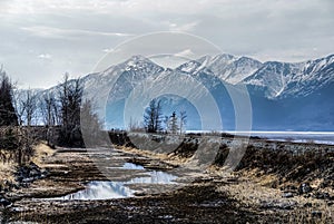 A Lake with Mountain Range Reflected in the Partially Frozen Waters of a Lake in the Great Alaskan Wilderness.