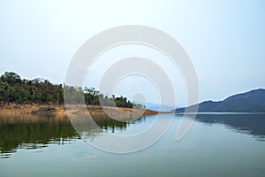 Lake and mountain scenery with beautiful blue sky and white clouds at Kaeng Krachan Dam in Thailand