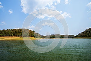 Lake and mountain scenery with beautiful blue sky and white clouds at Kaeng Krachan Dam in Thailand