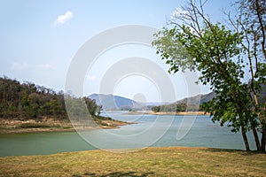 Lake and mountain scenery with beautiful blue sky and white clouds at Kaeng Krachan Dam in Thailand