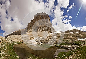 Lake in mountains with big rock in Turkey Aladaglar