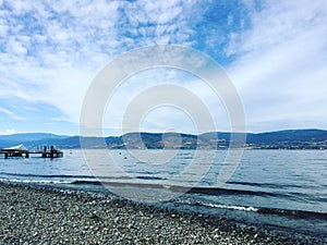 Lake shore and beach with boat on dock