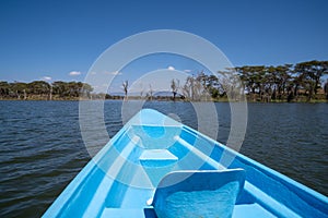 Lake Naivasha - tourist boat canoe sails to Crescent Island for a safari. Kenya, East Africa