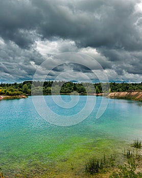 lake near the forest on a cloudy gloomy summer day