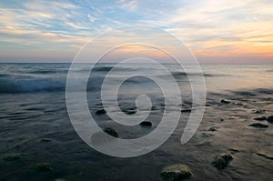 Lake Ontario sunset with smoothed water over rocks