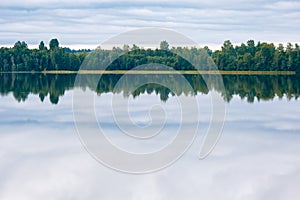 A lake, perfect reflection, clouds, and forest