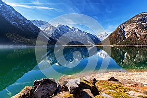 Lake Plansee with mountains reflecting in the water, Tyrol, Austria