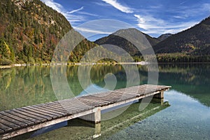 Lake Plansee with pier in Austria during autumn