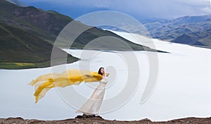 The lake on the plateau, young women stand in the wind