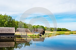 Lake with reeds and boathouses in Prerow, Germany