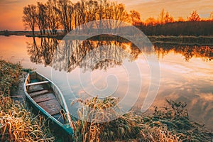 Lake River And Old Wooden Blue Rowing Fishing Boat At Beautiful Sunrise In Autumn Morning. Autumn Peaceful Landscape