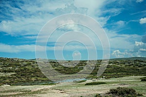 Lake on rocky landscape with domes of an old radar station