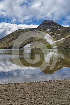 Lake Scaffaiolo and its reflections in May photo
