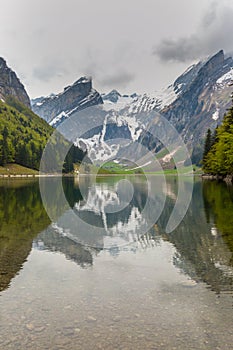 Lake Seealpsee, mirrored snowcapped mountain, clouds