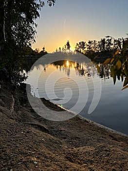 Sandy lake shore during dawn photo