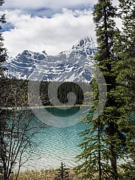 Lake and snow capped mountains on stormy day