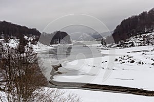 Lake of the springs of Aoos in the mountains Epirus region, Greece in winter on a cloudy day