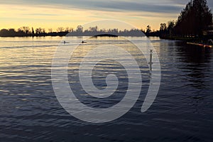 Lake at sunset with the sky casted in the water seen from the shore