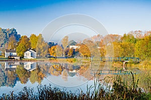 The lake is surrounded by autumn trees reflected in the mirror surface of the lake