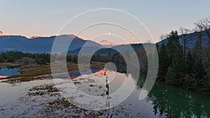 Lake surrounded by Mountains and Trees in Canadian Nature. Fall Season, Sunset Sky. Squamish BC