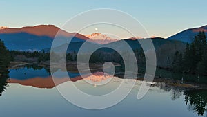 Lake surrounded by Mountains and Trees in Canadian Nature. Fall Season, Sunset Sky. Squamish BC