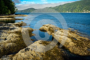 Lake surrounded by rocks and forests in Port Renfrew in Vancouver Island, Canad photo