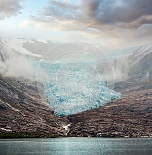 Lake Svartisvatnet and hazy cloudy view to Svartisen Glacier Meloy, Norway