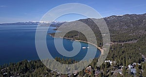 Lake Tahoe coastline and mountains covered by snow