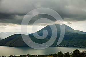 Lake Toba Danau Toba and Pusubukit Volcano under heavy clouds