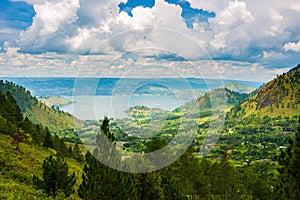 Lake Toba and Samosir Island view from above Sumatra Indonesia. Huge volcanic caldera covered by water, traditional Batak villages
