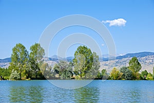 Lake, Trees, Mountains and Wispy Cloud