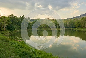 Lake and tropical rain-forest in cloudy day morning.