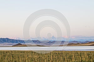 Lake Tuzkol in Kazakhstan and a view of Khan Tengri peak at sunrise